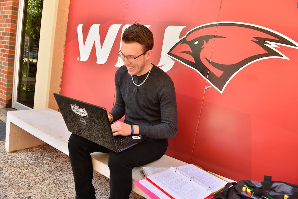 An alumnus updating their contact information on campus