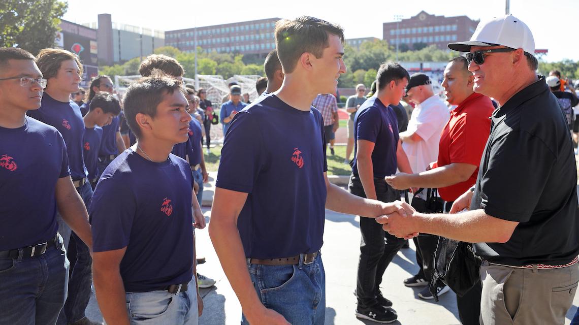 Dr. Thomas Evans shaking hands with new marine enlistee 
